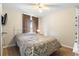 Cozy bedroom with a double bed and window access at 12512 Tillingham Sw Ct, Orlando, FL 32837