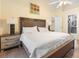 Main bedroom with king-size bed, ensuite bathroom access, and ceiling fan at 12512 Tillingham Sw Ct, Orlando, FL 32837