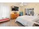 Bright bedroom with a queen bed, dresser, and sliding doors leading to a patio at 12512 Tillingham Sw Ct, Orlando, FL 32837