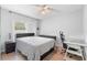 Bedroom with a double bed, nightstand, and workspace at 12512 Tillingham Sw Ct, Orlando, FL 32837