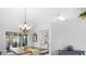 Spacious dining room with a farmhouse table and chandelier at 12512 Tillingham Sw Ct, Orlando, FL 32837