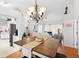 Charming dining room with rustic wooden table and chandelier at 12512 Tillingham Sw Ct, Orlando, FL 32837