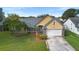 Nice curb appeal with a well-maintained lawn and driveway at 12512 Tillingham Sw Ct, Orlando, FL 32837