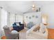 Relaxing living room featuring comfortable seating and large windows at 12512 Tillingham Sw Ct, Orlando, FL 32837