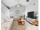 Large living area featuring a sectional sofa and a big screen TV at 12512 Tillingham Sw Ct, Orlando, FL 32837