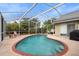 Refreshing kidney-shaped pool with brick coping and screened enclosure at 12512 Tillingham Sw Ct, Orlando, FL 32837
