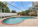 Inviting kidney-shaped pool with screened enclosure at 12512 Tillingham Sw Ct, Orlando, FL 32837