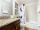Bathroom with tub, shower, and Mickey Mouse themed curtain at 1522 Moon Valley Dr, Davenport, FL 33896