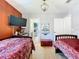 Thematic bedroom with twin beds and adjacent bathroom at 1522 Moon Valley Dr, Davenport, FL 33896