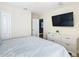 Bedroom with king bed, dresser, and wall-mounted TV at 1522 Moon Valley Dr, Davenport, FL 33896