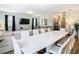 Modern dining room with a large white table and white chairs at 1522 Moon Valley Dr, Davenport, FL 33896