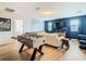 Game room featuring foosball table, comfy sofa, and large TV at 1522 Moon Valley Dr, Davenport, FL 33896
