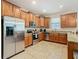 Kitchen with wood cabinets, granite countertops, and stainless steel appliances at 1522 Moon Valley Dr, Davenport, FL 33896