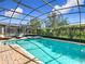 Inviting pool and spa area with screened enclosure and patio at 1522 Moon Valley Dr, Davenport, FL 33896