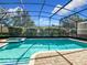 Refreshing screened pool and spa, perfect for relaxation at 1522 Moon Valley Dr, Davenport, FL 33896