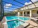 Large pool and spa with screened enclosure and patio furniture at 1522 Moon Valley Dr, Davenport, FL 33896