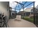 Screened patio with lounge chairs and pool access at 2770 Bookmark Dr, Kissimmee, FL 34746