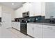 Modern kitchen with white cabinets, gray countertops, and stainless steel appliances at 2770 Bookmark Dr, Kissimmee, FL 34746