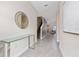 Light and bright entryway with glass console table and mirror at 2770 Bookmark Dr, Kissimmee, FL 34746
