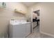Convenient laundry room with washer, dryer, and shelving at 2770 Bookmark Dr, Kissimmee, FL 34746