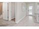 Bright entryway with tile floors, a glass-top console table, and access to the bathroom at 2770 Bookmark Dr, Kissimmee, FL 34746