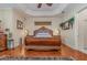 Main bedroom with hardwood floors, large bed, and ceiling fan at 36 Allenwood Look, Ormond Beach, FL 32174