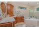 Bathroom features a large soaking tub, double vanity, and corner shower at 36 Allenwood Look, Ormond Beach, FL 32174