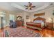 Spacious main bedroom with hardwood floors, a large bed, and a ceiling fan at 36 Allenwood Look, Ormond Beach, FL 32174