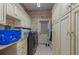 Laundry room boasts ample cabinetry and a washer and dryer at 36 Allenwood Look, Ormond Beach, FL 32174