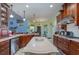 Spacious kitchen with island, wood cabinetry, and granite countertops at 36 Allenwood Look, Ormond Beach, FL 32174