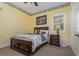 Cozy bedroom with a double bed, dark wood furniture, and yellow walls at 36 Allenwood Look, Ormond Beach, FL 32174