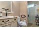 Elegant bathroom with a beige vanity, toilet, and glass shower at 36 Allenwood Look, Ormond Beach, FL 32174