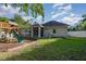 Spacious backyard with playset and home exterior view at 36 Allenwood Look, Ormond Beach, FL 32174