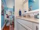 Bright bathroom with white vanity, granite countertop, and large mirror at 36 Allenwood Look, Ormond Beach, FL 32174