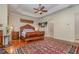 Main bedroom with hardwood floors, large bed, and ceiling fan at 36 Allenwood Look, Ormond Beach, FL 32174