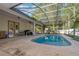 Inviting screened pool area with a large pool and playset at 36 Allenwood Look, Ormond Beach, FL 32174