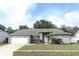 One-story house with a grey brick exterior and a white garage door at 4230 Meeting Pl, Sanford, FL 32773