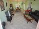 Living room with brown leather sofas and a view of the dining area at 721 S Beach St # 217A, Daytona Beach, FL 32114