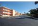 Exterior view of a light peach two-story condominium building with ample parking at 721 S Beach St # 217A, Daytona Beach, FL 32114