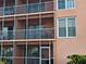Building exterior showcasing multiple balconies and pastel facade at 721 S Beach St # 217A, Daytona Beach, FL 32114