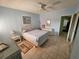 Light blue bedroom with a double bed and wicker furniture at 721 S Beach St # 217A, Daytona Beach, FL 32114