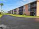 Building exterior view with ample parking and landscaping at 721 S Beach St # 217A, Daytona Beach, FL 32114