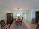 Dining room with wooden table and chairs and a light green wall at 721 S Beach St # 217A, Daytona Beach, FL 32114