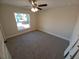 Spacious bedroom with carpeted floors and large window at 8749 Se 159Th Ln, Summerfield, FL 34491