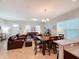 Open concept dining area with wooden table and chairs at 9344 Tyrella Pine Trl, Winter Garden, FL 34787