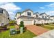 Two story townhome with two-car garage and brick paver driveway at 1174 Seaside Mist Trl, Kissimmee, FL 34747