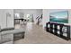 Open concept living room with view of kitchen and staircase at 1174 Seaside Mist Trl, Kissimmee, FL 34747