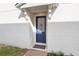 Blue door side entrance with brick walkway at 1174 Seaside Mist Trl, Kissimmee, FL 34747
