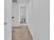 Hallway with carpet and doors to bedrooms at 1174 Seaside Mist Trl, Kissimmee, FL 34747