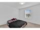 Bedroom with full-size bed and window overlooking the community at 1174 Seaside Mist Trl, Kissimmee, FL 34747
